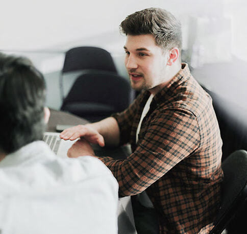 Two people talking in an office setting